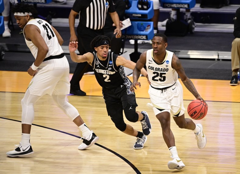 Mar 20, 2021; Indianapolis, Indiana, USA; Colorado Buffaloes guard McKinley Wright IV (25) dribbles against Georgetown Hoyas guard Dante Harris (2) during the first round of the 2021 NCAA Tournament at Hinkle Fieldhouse. Mandatory Credit: Marc Lebryk-USA TODAY Sports