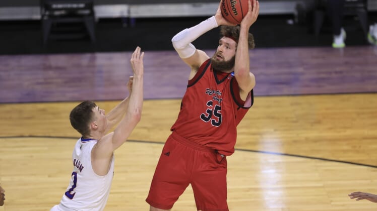 Mar 20, 2021; Indianapolis, IN, USA; Eastern Washington Eagles forward Tanner Groves (35) shoots over Kansas Jayhawks guard Christian Braun (2) during the first round of the 2021 NCAA Tournament at Indiana Farmers Coliseum.  Mandatory Credit: Aaron Doster-USA TODAY Sports