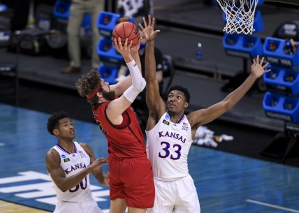 Mar 20, 2021; Indianapolis, IN, USA; Kansas Jayhawks forward David McCormack (33) and guard Ochai Agbaji (30) defend against Eastern Washington Eagles forward Tanner Groves (35) during the first round of the 2021 NCAA Tournament at Indiana Farmers Coliseum.  Mandatory Credit: Aaron Doster-USA TODAY Sports