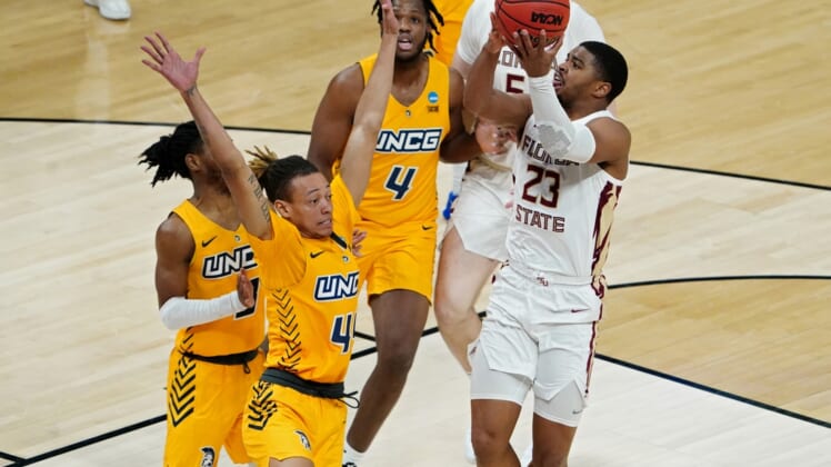 Mar 20, 2021; Indianapolis, Indiana, USA; Florida State Seminoles guard M.J. Walker (23) shoots the ball while defended by UNCG Spartans guard Kaleb Hunter (44) during the second half in the first round of the 2021 NCAA Tournament at Bankers Life Fieldhouse. Mandatory Credit: Kirby Lee-USA TODAY Sports