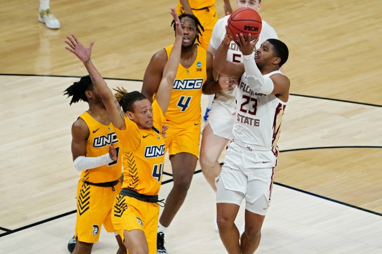 Mar 20, 2021; Indianapolis, Indiana, USA; Florida State Seminoles guard M.J. Walker (23) shoots the ball while defended by UNCG Spartans guard Kaleb Hunter (44) during the second half in the first round of the 2021 NCAA Tournament at Bankers Life Fieldhouse. Mandatory Credit: Kirby Lee-USA TODAY Sports