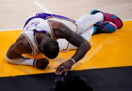 Mar 20, 2021; Los Angeles, California, USA; Los Angeles Lakers forward LeBron James (23) on the floor after injuring his leg in a collision for a loose ball during the second quarter against the Atlanta Hawks at Staples Center. Mandatory Credit: Robert Hanashiro-USA TODAY Sports