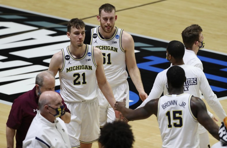 Mar 20, 2021; West Lafayette, Indiana, USA; Michigan Wolverines forward Austin Davis (51) reacts as he celebrates with teammates after defeating the Texas Southern Tigers in the first round of the 2021 NCAA Tournament at Mackey Arena. Mandatory Credit: Joshua Bickel-USA TODAY Sports