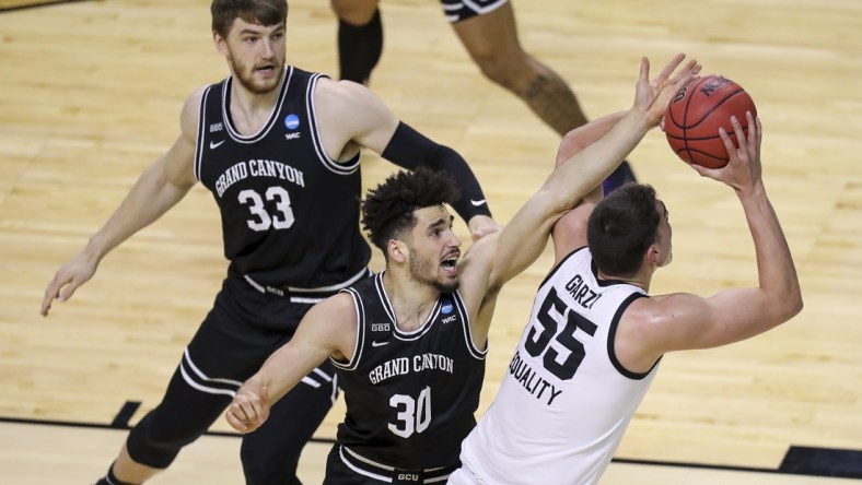 Mar 20, 2021; Indianapolis, IN, USA; Grand Canyon Antelopes center Asbj rn Midtgaard (33) and forward Gabe McGlothan (30) defend against Iowa Hawkeyes center Luka Garza (55) during the first round of the 2021 NCAA Tournament at Indiana Farmers Coliseum.  Mandatory Credit: Katie Stratman-USA TODAY Sports