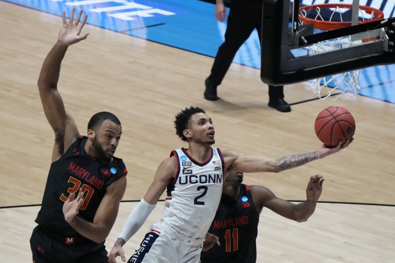 Mar 20, 2021; West Lafayette, Indiana, USA; Connecticut Huskies guard James Bouknight (2) shoots the ball against Maryland Terrapins forward Galin Smith (30) and guard Darryl Morsell (11) during the first half in the first round of the 2021 NCAA Tournament at Mackey Arena. Mandatory Credit: Mike Dinovo-USA TODAY Sports