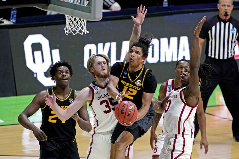 Mar 20, 2021; Indianapolis, Indiana, USA; Missouri Tigers guard Dru Smith (12) shoots the ball against Oklahoma Sooners forward Brady Manek (35) during the first half in the first round of the 2021 NCAA Tournament at Lucas Oil Stadium. Mandatory Credit:  Andrew Nelles-USA TODAY Sports
