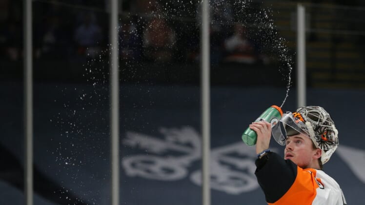 Mar 20, 2021; Uniondale, New York, USA; Philadelphia Flyers goalie Carter Hart (79) sprays water before taking a drink during the second period against the New York Islanders at Nassau Veterans Memorial Coliseum. Mandatory Credit: Brad Penner-USA TODAY Sports