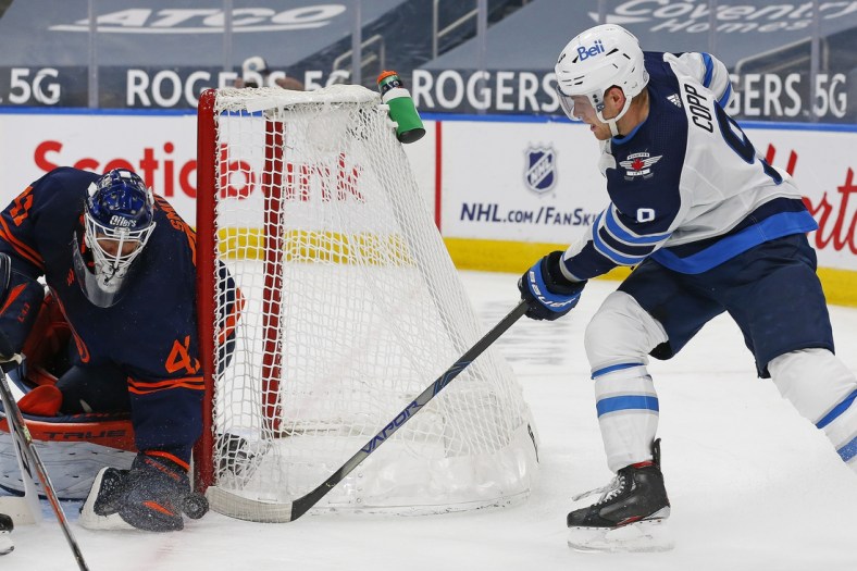 Mar 20, 2021; Edmonton, Alberta, CAN; Edmonton Oilers goaltender Mike Smith (41) makes a save on Winnipeg Jets forward Andrew Copp (9) during the second period at Rogers Place. Mandatory Credit: Perry Nelson-USA TODAY Sports