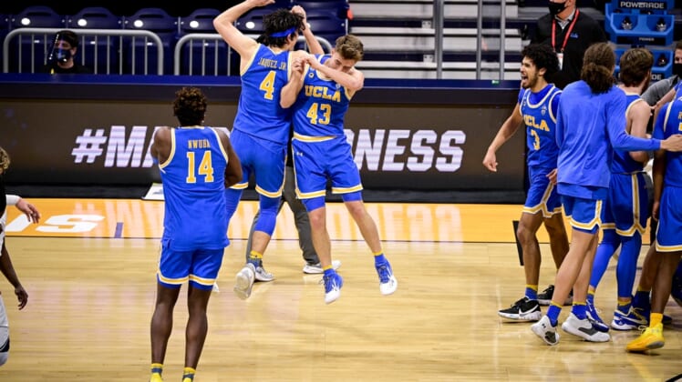 Mar 20, 2021; Indianapolis, IN, USA; The UCLA Bruins celebrate the win over the Brigham Young Cougars during the first round of the 2021 NCAA Tournament at Hinkle Fieldhouse.  Mandatory Credit: Marc Lebryk-USA TODAY Sports
