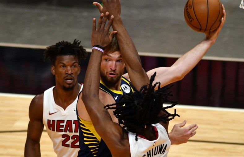 Mar 21, 2021; Miami, Florida, USA; Indiana Pacers forward Domantas Sabonis (11) looks to pass as Miami Heat forward Jimmy Butler (22) and forward Precious Achiuwa (5) defend on the play in the first quarter at American Airlines Arena. Mandatory Credit: Jim Rassol-USA TODAY Sports