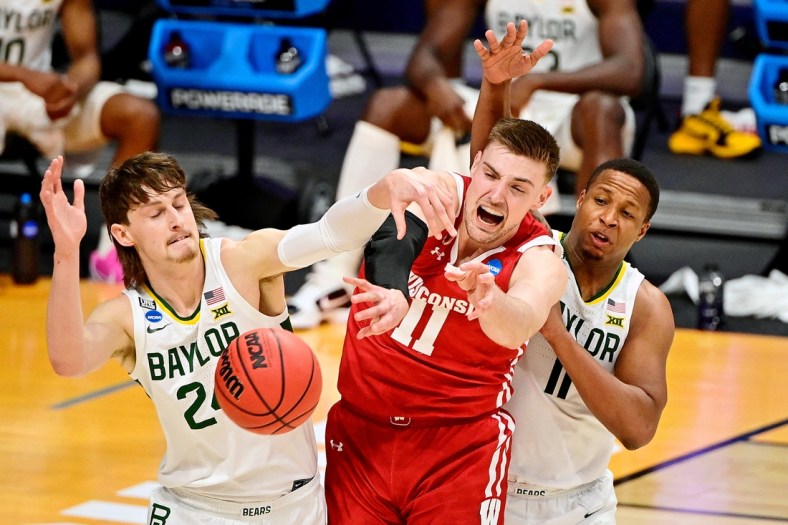 Mar 21, 2021; Indianapolis, Indiana, USA; Baylor Bears guard Matthew Mayer (left) and guard Mark Vital (right) battle for a loose ball with Wisconsin Badgers forward Micah Potter (11)  during the first half in the second round of the 2021 NCAA Tournament at Hinkle Fieldhouse. Mandatory Credit: Marc Lebryk-USA TODAY Sports