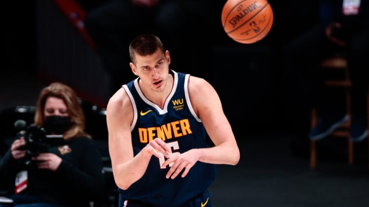 Mar 21, 2021; Denver, Colorado, USA; Denver Nuggets center Nikola Jokic (15) passes the ball in the second quarter against the New Orleans Pelicans at Ball Arena. Mandatory Credit: Isaiah J. Downing-USA TODAY Sports