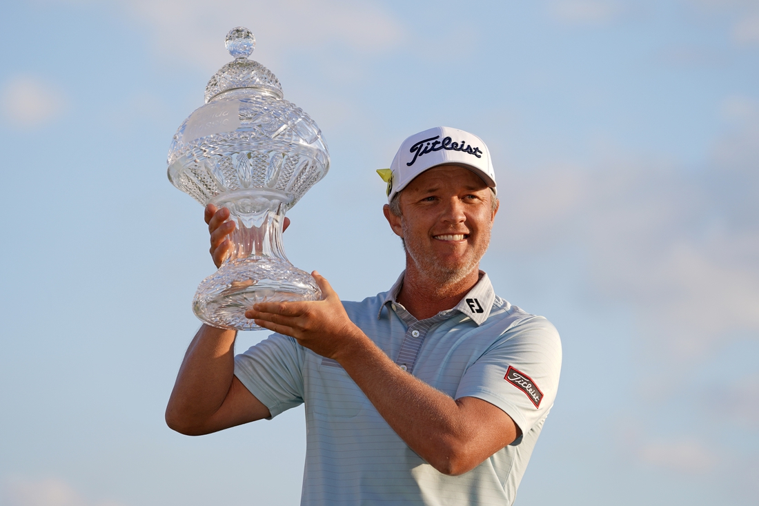 Mar 21, 2021; Palm Beach Gardens, Florida, USA; Matt Jones celebrates with the trophy after winning during The Honda Classic golf tournament. Mandatory Credit: Jasen Vinlove-USA TODAY Sports