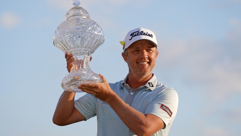 Mar 21, 2021; Palm Beach Gardens, Florida, USA; Matt Jones celebrates with the trophy after winning during The Honda Classic golf tournament. Mandatory Credit: Jasen Vinlove-USA TODAY Sports