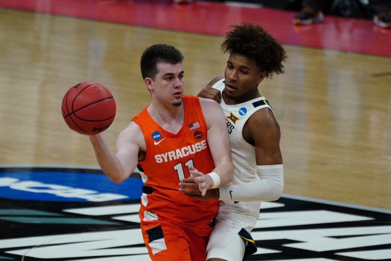 Mar 21, 2021; Indianapolis, Indiana, USA; Syracuse Orange guard Joseph Girard III (11) looks to move down court defended by West Virginia Mountaineers guard Miles McBride (4) in the second half in the second round of the 2021 NCAA Tournament at Bankers Life Fieldhouse. Mandatory Credit: Kirby Lee-USA TODAY Sports