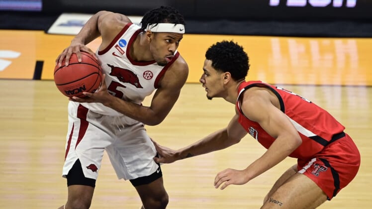 Mar 21, 2021; Indianapolis, Indiana, USA; Arkansas Razorbacks guard Moses Moody (5) holds the ball away from Texas Tech Red Raiders guard Micah Peavy (5) in the first half in the second round of the 2021 NCAA Tournament at Hinkle Fieldhouse. Mandatory Credit: Marc Lebryk-USA TODAY Sports