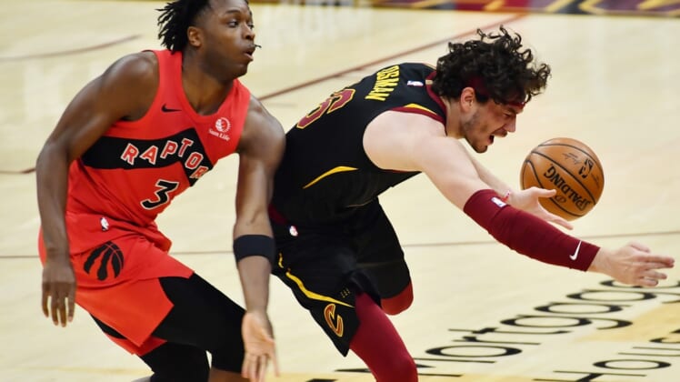 Mar 21, 2021; Cleveland, Ohio, USA; Toronto Raptors forward OG Anunoby (3) and Cleveland Cavaliers forward Cedi Osman (16) go for a loose ball during the second quarter at Rocket Mortgage FieldHouse. Mandatory Credit: Ken Blaze-USA TODAY Sports