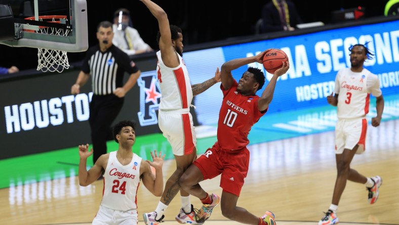 Mar 21, 2021; Indianapolis, Indiana, USA; Houston Cougars forward Justin Gorham (4) fouls Rutgers Scarlet Knights guard Montez Mathis (10) on a shot attempt during the first half in the second round of the 2021 NCAA Tournament at Lucas Oil Stadium. Mandatory Credit: Aaron Doster-USA TODAY Sports