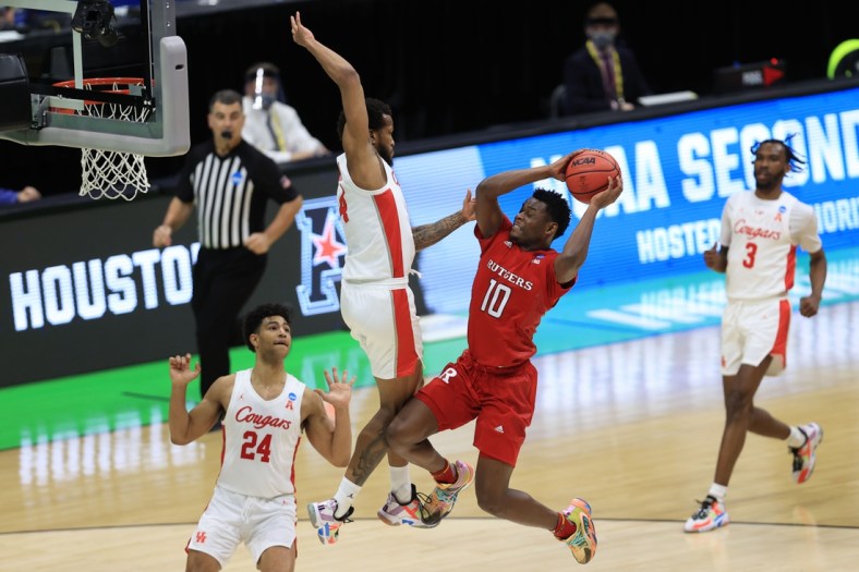 Mar 21, 2021; Indianapolis, Indiana, USA; Houston Cougars forward Justin Gorham (4) fouls Rutgers Scarlet Knights guard Montez Mathis (10) on a shot attempt during the first half in the second round of the 2021 NCAA Tournament at Lucas Oil Stadium. Mandatory Credit: Aaron Doster-USA TODAY Sports