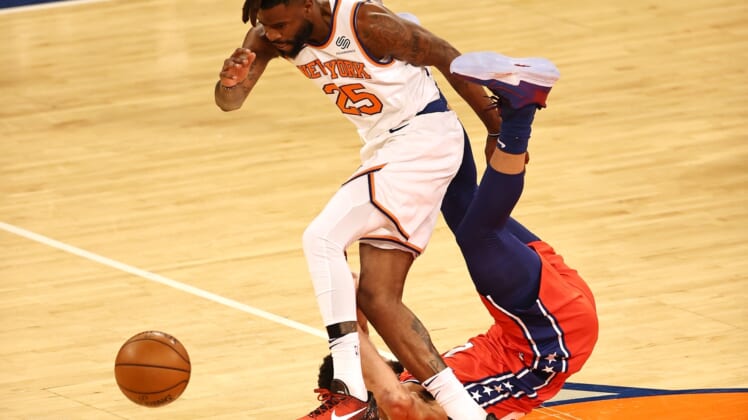 Mar 21, 2021; New York, New York, USA;   Reggie Bullock #25 of the New York Knicks and Ben Simmons #25 of the Philadelphia 76ers go after a loose ball in the first quarter at Madison Square Garden on March 21, 2021 in New York City. Mandatory Credit: Elsa/Pool Photo-USA TODAY Sports