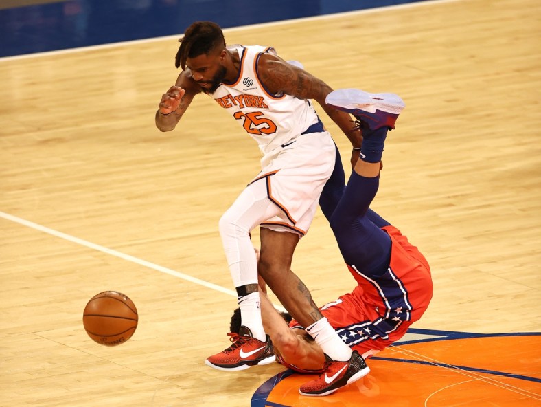 Mar 21, 2021; New York, New York, USA;   Reggie Bullock #25 of the New York Knicks and Ben Simmons #25 of the Philadelphia 76ers go after a loose ball in the first quarter at Madison Square Garden on March 21, 2021 in New York City. Mandatory Credit: Elsa/Pool Photo-USA TODAY Sports