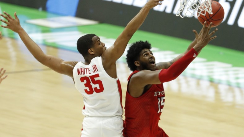 Mar 21, 2021; Indianapolis, Indiana, USA; Rutgers Scarlet Knights center Myles Johnson (15) goes up for a shot while Houston Cougars forward Fabian White Jr. (35) defends during the second half in the second round of the 2021 NCAA Tournament at Lucas Oil Stadium. Mandatory Credit: Joshua Bickel-USA TODAY Sports