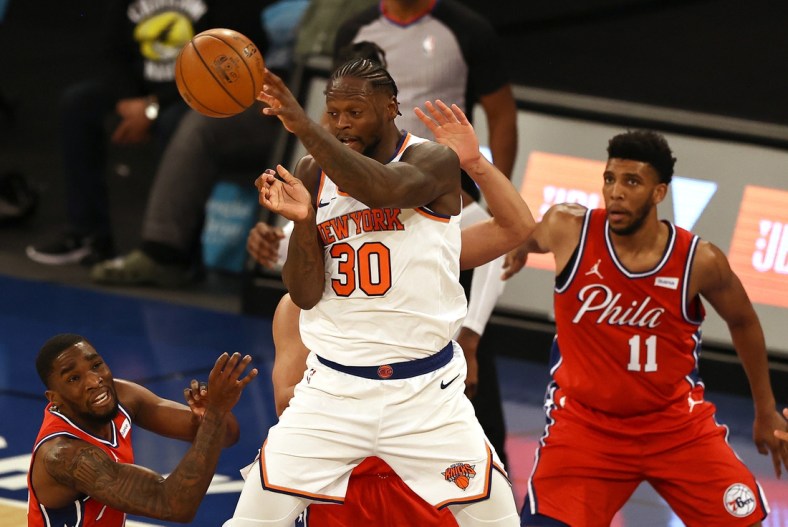 Mar 21, 2021; New York, New York, USA;  Julius Randle #30 of the New York Knicks passes the ball as Tony Bradley #11 and Shake Milton #18 of the Philadelphia 76ers defend in the second quarter at Madison Square Garden on March 21, 2021 in New York City.  Mandatory Credit: Elsa/Pool Photo-USA TODAY Sports