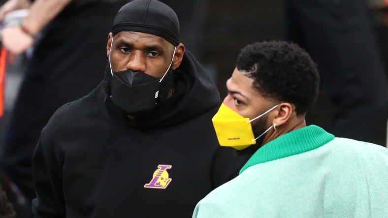 Mar 21, 2021; Phoenix, Arizona, USA; Los Angeles Lakers injured forward LeBron James (left) and Anthony Davis against the Phoenix Suns during the first half at Phoenix Suns Arena. Mandatory Credit: Mark J. Rebilas-USA TODAY Sports