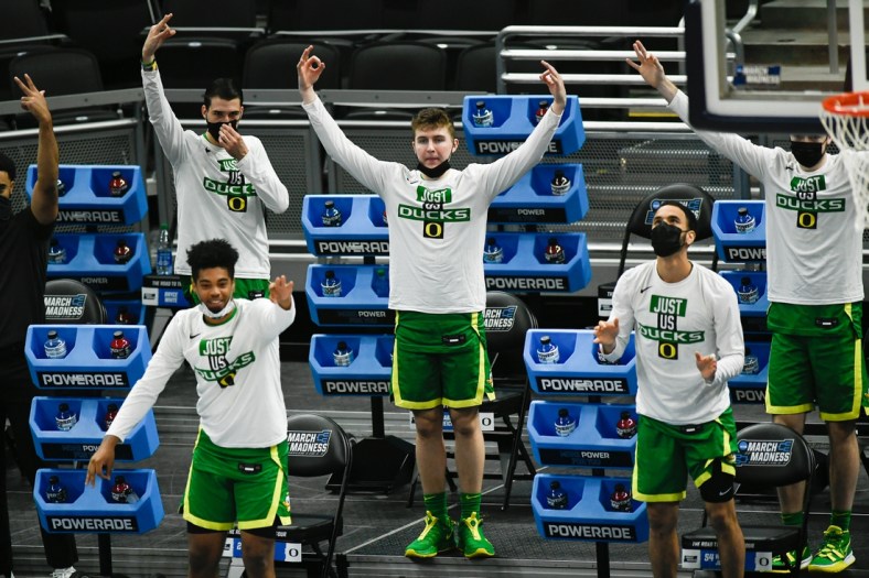 The Oregon Ducks react to guard Will Richardson (0) scoring a three-pointer during their game against the Iowa Hawkeyes in the second round of the 2021 NCAA Tournament on Monday, March 22, 2021, at Bankers Life Fieldhouse in Indianapolis, Ind. Mandatory Credit: Sam Owens/IndyStar via USA TODAY Sports