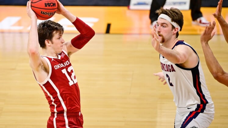 Mar 22, 2021; Indianapolis, Indiana, USA; Oklahoma Sooners guard Austin Reaves (12) looks to pass while defended by Gonzaga Bulldogs forward Drew Timme (2) during the second half in the second round of the 2021 NCAA Tournament at Hinkle Fieldhouse. Mandatory Credit: Marc Lebryk-USA TODAY Sports