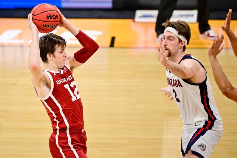 Mar 22, 2021; Indianapolis, Indiana, USA; Oklahoma Sooners guard Austin Reaves (12) looks to pass while defended by Gonzaga Bulldogs forward Drew Timme (2) during the second half in the second round of the 2021 NCAA Tournament at Hinkle Fieldhouse. Mandatory Credit: Marc Lebryk-USA TODAY Sports