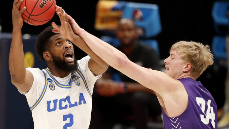 UCLA Bruins forward Cody Riley (2) is fouled by Abilene Christian Wildcats center Kolton Kohl (34) during the second round of the 2021 NCAA Tournament on Monday, March 22, 2021, at Bankers Life Fieldhouse in Indianapolis, Ind. Mandatory Credit: Michael Caterina/IndyStar via USA TODAY Sports