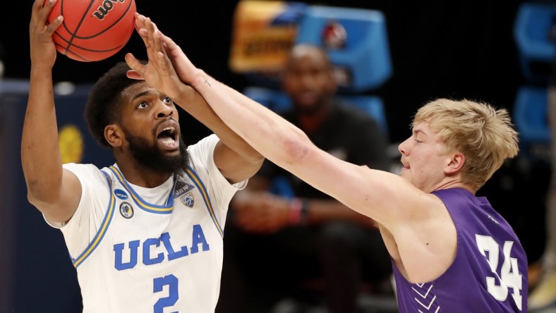 UCLA Bruins forward Cody Riley (2) is fouled by Abilene Christian Wildcats center Kolton Kohl (34) during the second round of the 2021 NCAA Tournament on Monday, March 22, 2021, at Bankers Life Fieldhouse in Indianapolis, Ind. Mandatory Credit: Michael Caterina/IndyStar via USA TODAY Sports