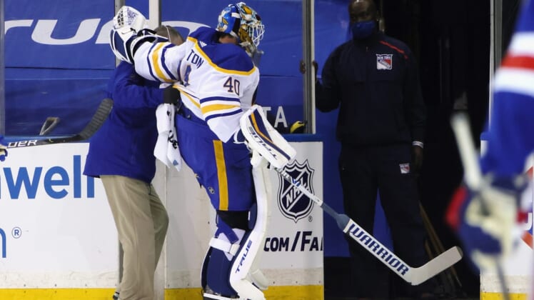Mar 22, 2021; New York, New York, USA;  Buffalo Sabres goaltender Carter Hutton (40)  is assisted off the ice following a first period injury against the New York Rangers at Madison Square Garden. Mandatory Credit: Bruce Bennett/POOL PHOTOS-USA TODAY Sports