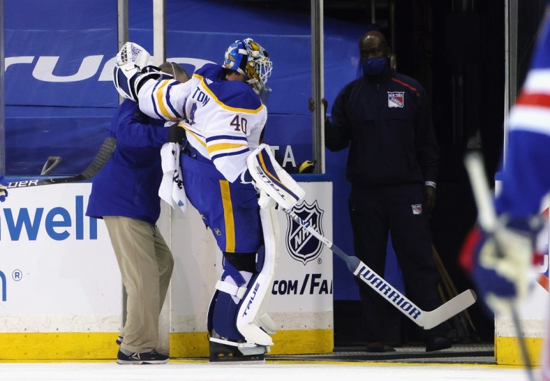 Mar 22, 2021; New York, New York, USA;  Buffalo Sabres goaltender Carter Hutton (40)  is assisted off the ice following a first period injury against the New York Rangers at Madison Square Garden. Mandatory Credit: Bruce Bennett/POOL PHOTOS-USA TODAY Sports