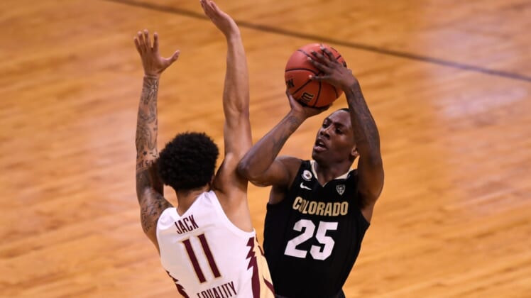 Mar 22, 2021; Indianapolis, Indiana, USA; Colorado Buffaloes guard McKinley Wright IV (25) makes contact with Florida State Seminoles guard Nathanael Jack (11) when attempting to shoot in the first half in the second round of the 2021 NCAA Tournament at Indiana Farmers Coliseum. Mandatory Credit: Doug McSchooler-USA TODAY Sports
