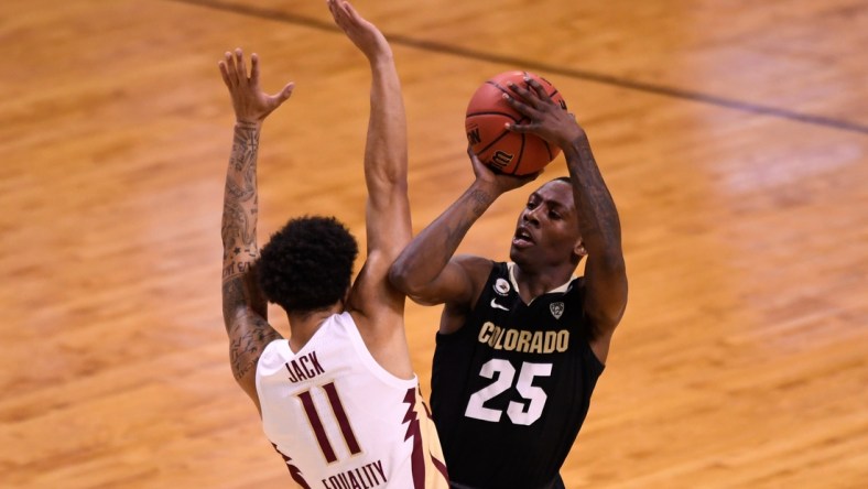 Mar 22, 2021; Indianapolis, Indiana, USA; Colorado Buffaloes guard McKinley Wright IV (25) makes contact with Florida State Seminoles guard Nathanael Jack (11) when attempting to shoot in the first half in the second round of the 2021 NCAA Tournament at Indiana Farmers Coliseum. Mandatory Credit: Doug McSchooler-USA TODAY Sports