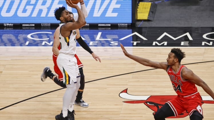 Mar 22, 2021; Chicago, Illinois, USA; Utah Jazz guard Donovan Mitchell (45) shoots against Chicago Bulls center Wendell Carter Jr. (34) during the first half of an NBA game at United Center. Mandatory Credit: Kamil Krzaczynski-USA TODAY Sports