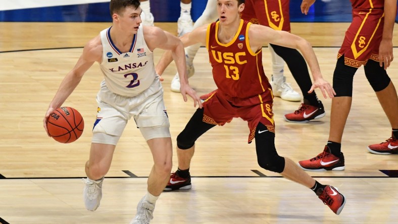 Mar 22, 2021; Indianapolis, Indiana, USA; Kansas Jayhawks guard Christian Braun (2) handles the ball while Southern California Trojans guard Drew Peterson (13) defends during the first half in the second round of the 2021 NCAA Tournament at Hinkle Fieldhouse. Mandatory Credit: Patrick Gorski-USA TODAY Sports