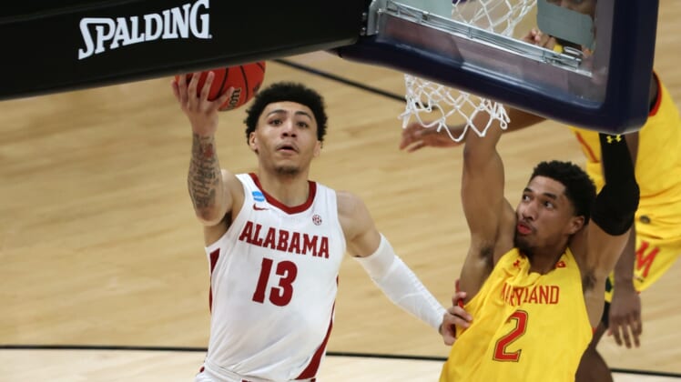 Mar 22, 2021; Indianapolis, Indiana, USA; Alabama Crimson Tide guard Jahvon Quinerly (13) shoots against Maryland Terrapins guard Aaron Wiggins (2) in the second half in the second round of the 2021 NCAA Tournament at Bankers Life Fieldhouse. Mandatory Credit: Trevor Ruszkowski-USA TODAY Sports