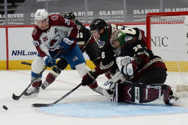 Mar 22, 2021; Glendale, Arizona, USA; Colorado Avalanche center Nathan MacKinnon (29) drives to the front of the Arizona Coyotes net during the second period at Gila River Arena. Mandatory Credit: Joe Camporeale-USA TODAY Sports