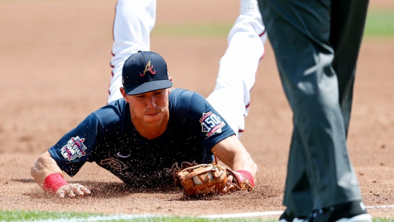 Mar 23, 2021; North Port, Florida, USA; Atlanta Braves third baseman Jake Lamb (24) dives for a ball against the Boston Red Sox in the third inning during spring training at CoolToday Park. Mandatory Credit: Nathan Ray Seebeck-USA TODAY Sports