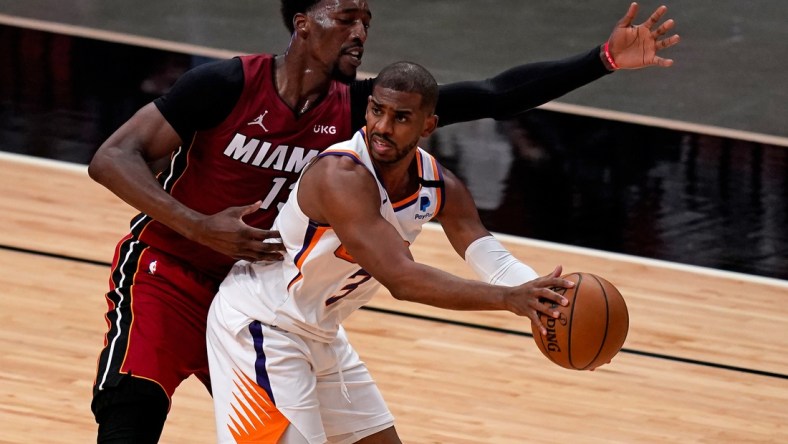 Mar 23, 2021; Miami, Florida, USA; Phoenix Suns guard Chris Paul (3) controls the ball around Miami Heat center Bam Adebayo (13) during the first half at American Airlines Arena. Mandatory Credit: Jasen Vinlove-USA TODAY Sports