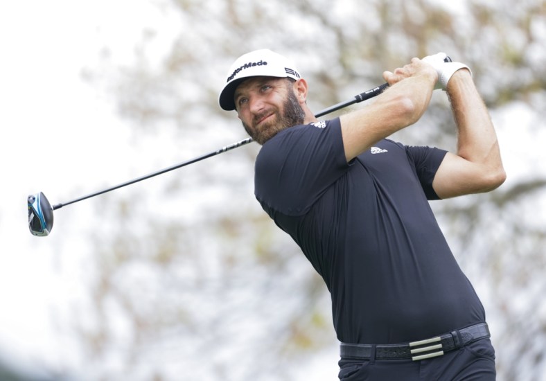 Mar 24, 2021; Austin, Texas, USA; Dustin Johnson plays his shot from the sixth tee during the first day of the WGC Dell Technologies Match Play golf tournament at Austin Country Club. Mandatory Credit: Erich Schlegel-USA TODAY Sports