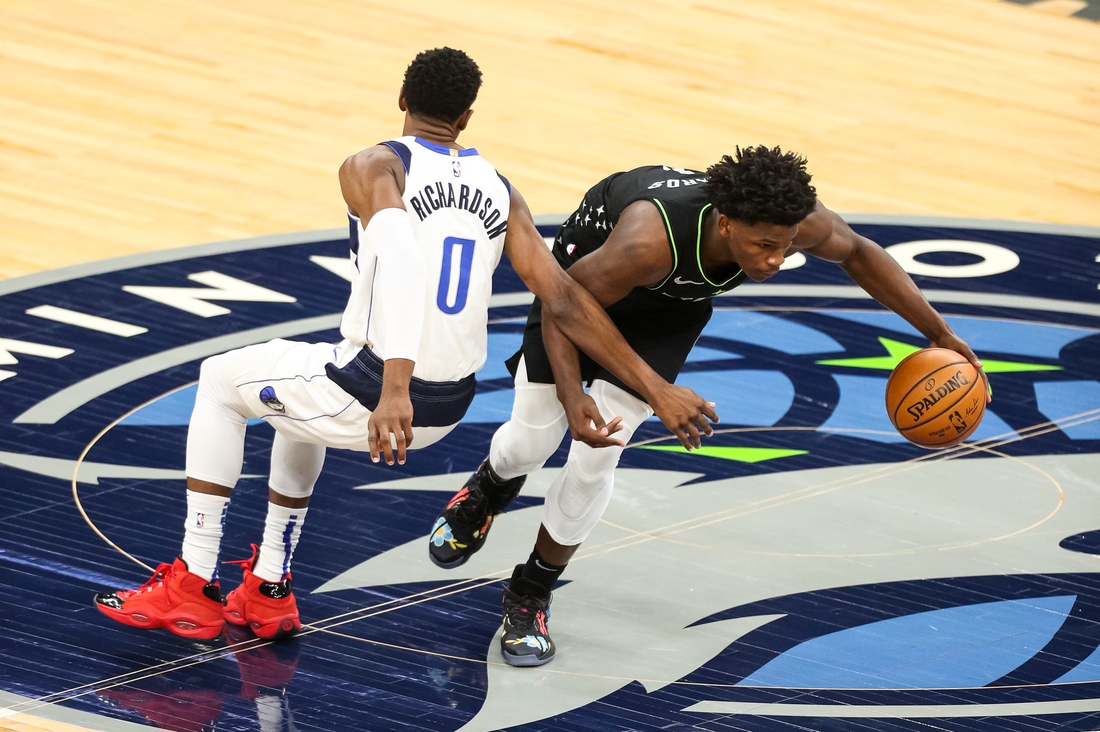 Mar 24, 2021; Minneapolis, Minnesota, USA; Minnesota Timberwolves forward Anthony Edwards (1) dribbles the ball past Dallas Mavericks guard Josh Richardson (0) in the first quarter at Target Center. Mandatory Credit: David Berding-USA TODAY Sports