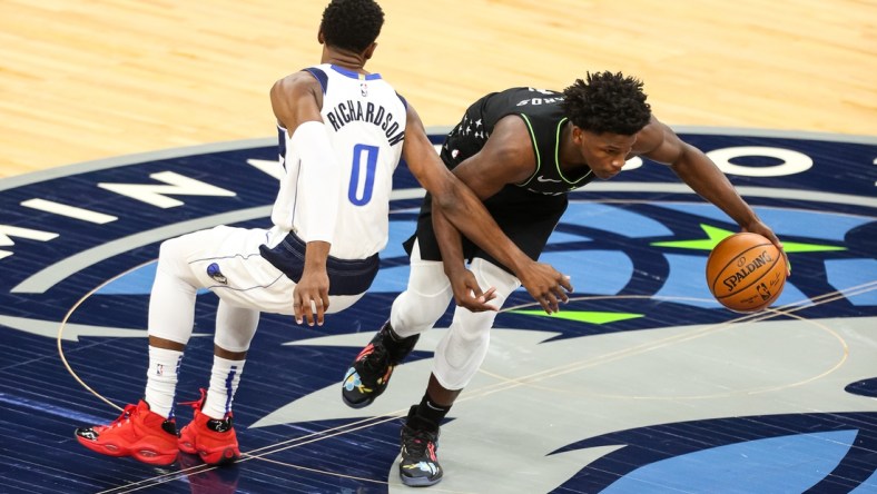 Mar 24, 2021; Minneapolis, Minnesota, USA; Minnesota Timberwolves forward Anthony Edwards (1) dribbles the ball past Dallas Mavericks guard Josh Richardson (0) in the first quarter at Target Center. Mandatory Credit: David Berding-USA TODAY Sports