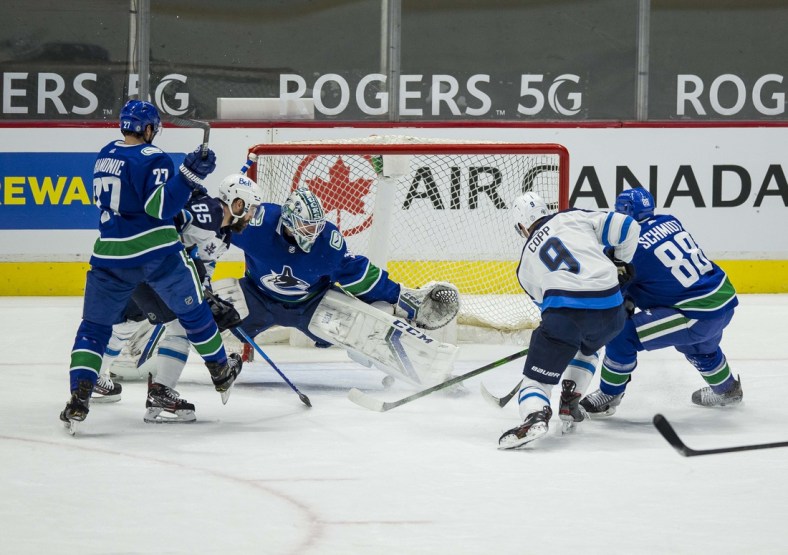 Mar 24, 2021; Vancouver, British Columbia, CAN;  Winnipeg Jets forward Andrew Copp (9) scores a goal on Vancouver Canucks goalie Thatcher Demko (35) in the second period at Rogers Arena. Mandatory Credit: Bob Frid-USA TODAY Sports