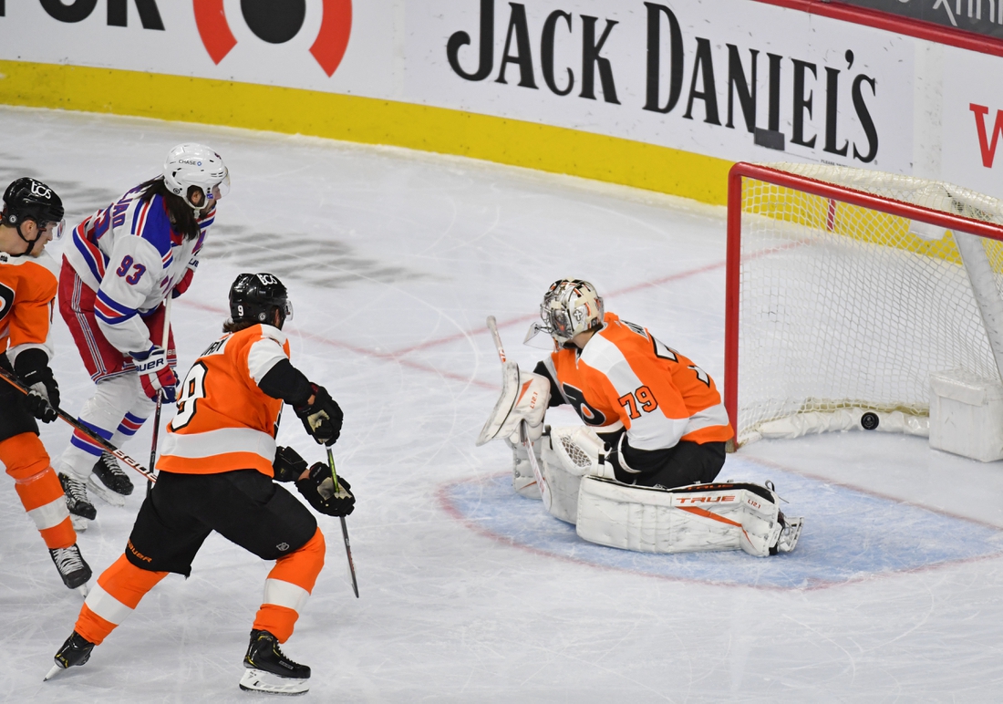 Mar 25, 2021; Philadelphia, Pennsylvania, USA; New York Rangers center Mika Zibanejad (93) scores a goal against Philadelphia Flyers goaltender Carter Hart (79) during the first period at Wells Fargo Center. Mandatory Credit: Eric Hartline-USA TODAY Sports