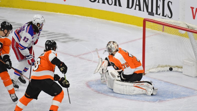 Mar 25, 2021; Philadelphia, Pennsylvania, USA; New York Rangers center Mika Zibanejad (93) scores a goal against Philadelphia Flyers goaltender Carter Hart (79) during the first period at Wells Fargo Center. Mandatory Credit: Eric Hartline-USA TODAY Sports