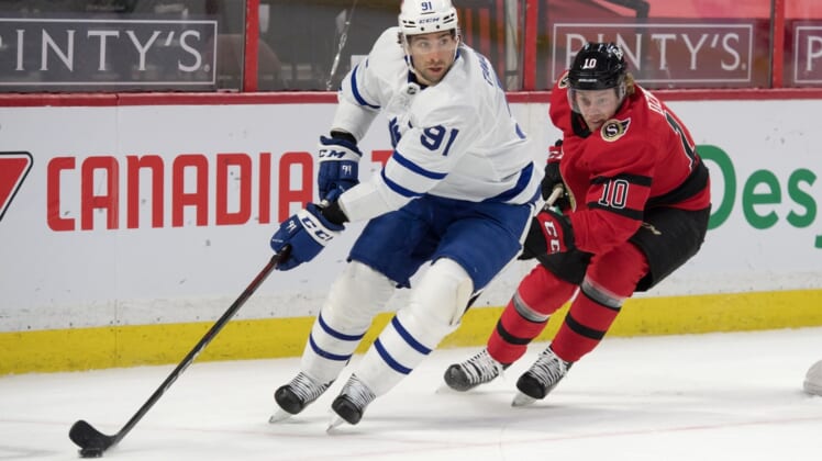 Mar 25, 2021; Ottawa, Ontario, CAN; Toronto Maple Leafs center John Tavares (91) skates with the puck in front of  Ottawa Senators left wing Ryan Dzingel (10) in the first period at the Canadian Tire Centre. Mandatory Credit: Marc DesRosiers-USA TODAY Sports
